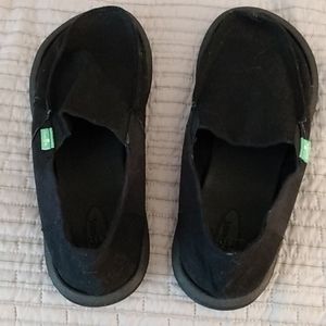 Black Sanuk loafer style shoes